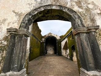 a stone walkway with arched doorways