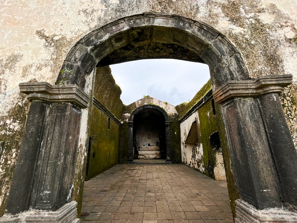 a stone walkway with arched doorways