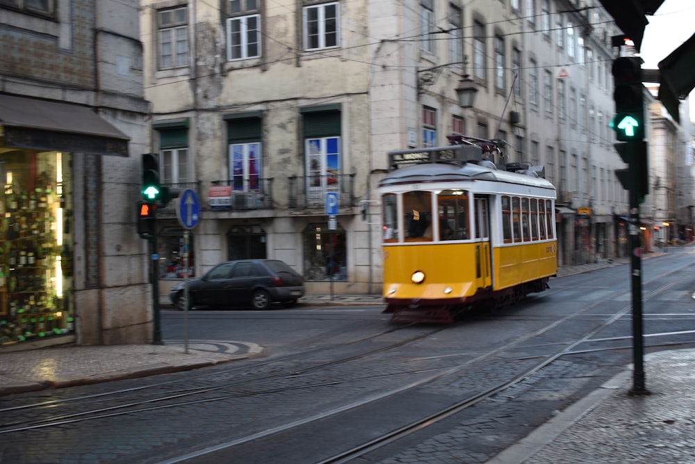 a yellow trolley on a city street