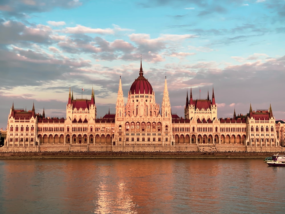 a large building with a domed roof with Hungarian Parliament Building in the background