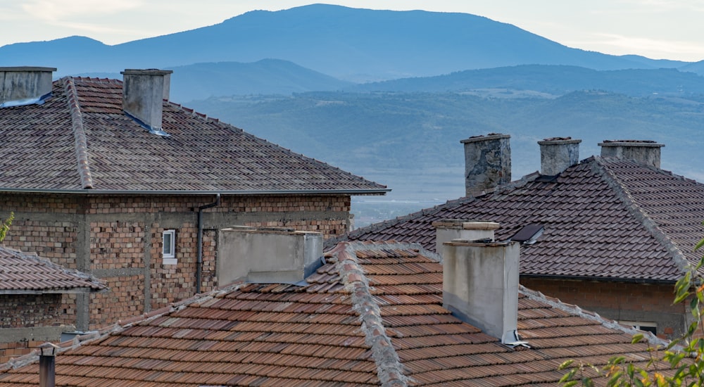 a roof of a house with a view of a lake and mountains