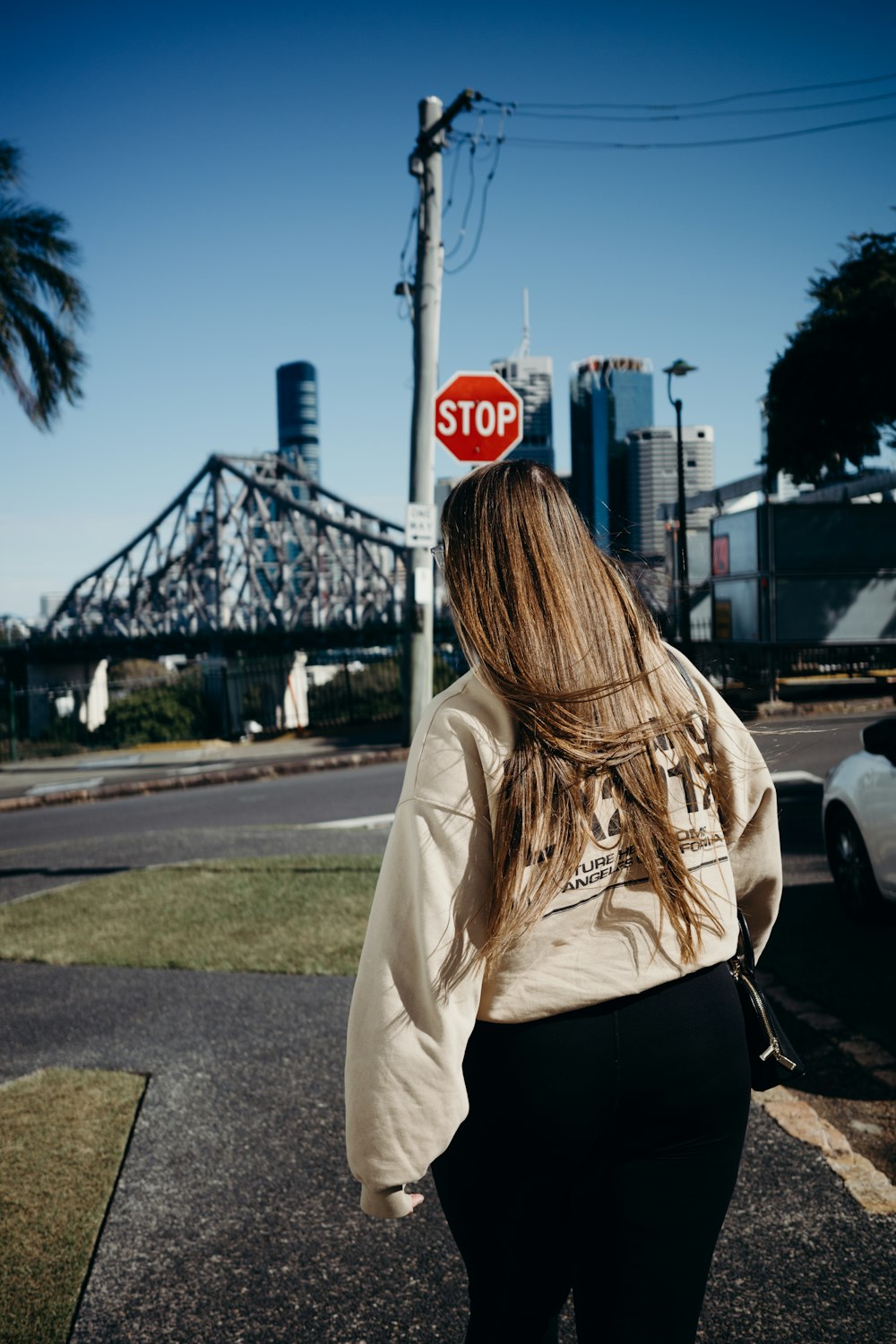 a person standing next to a stop sign