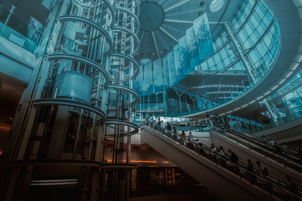 a large glass building with people inside