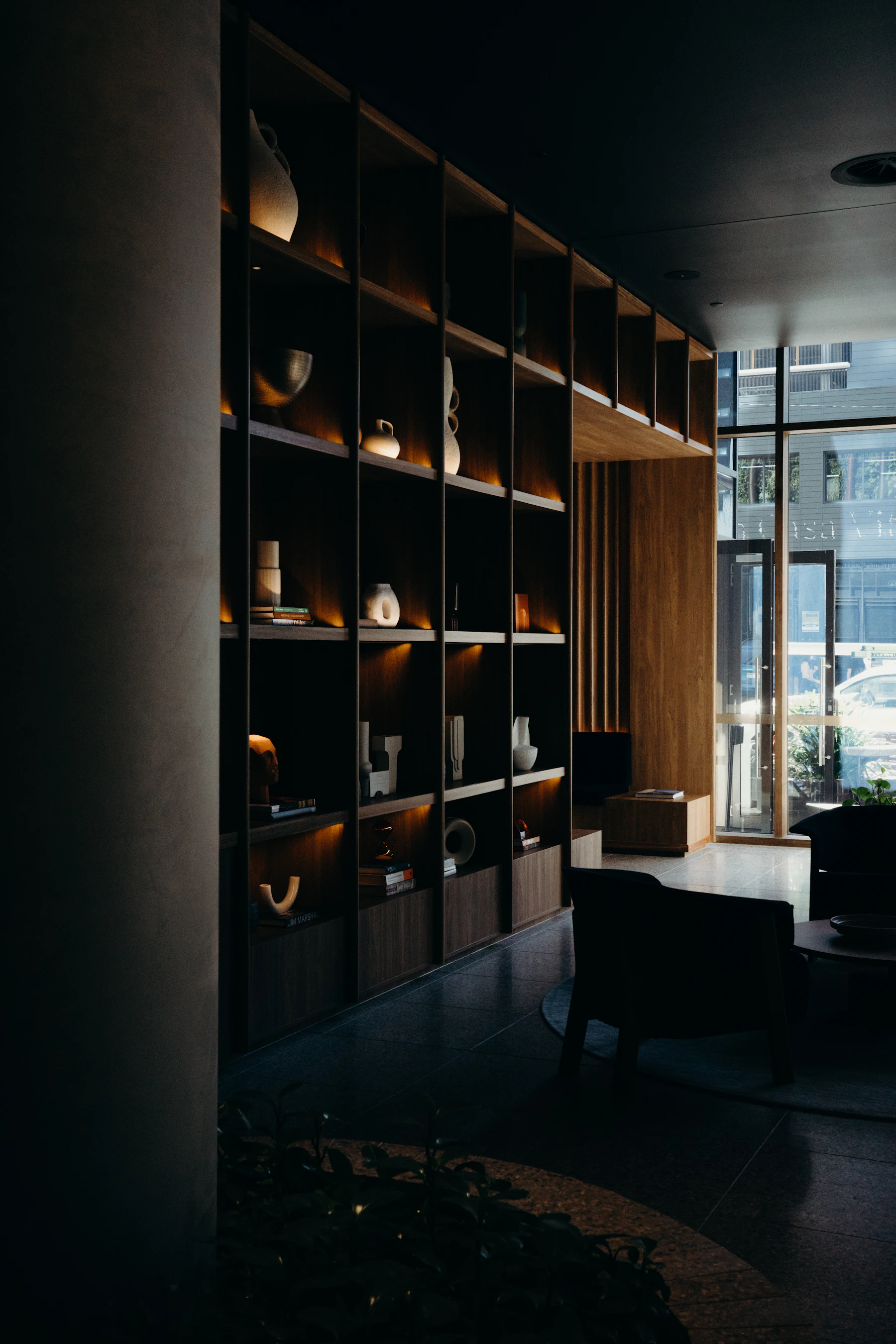 Apartment building lobby with seating and large windows