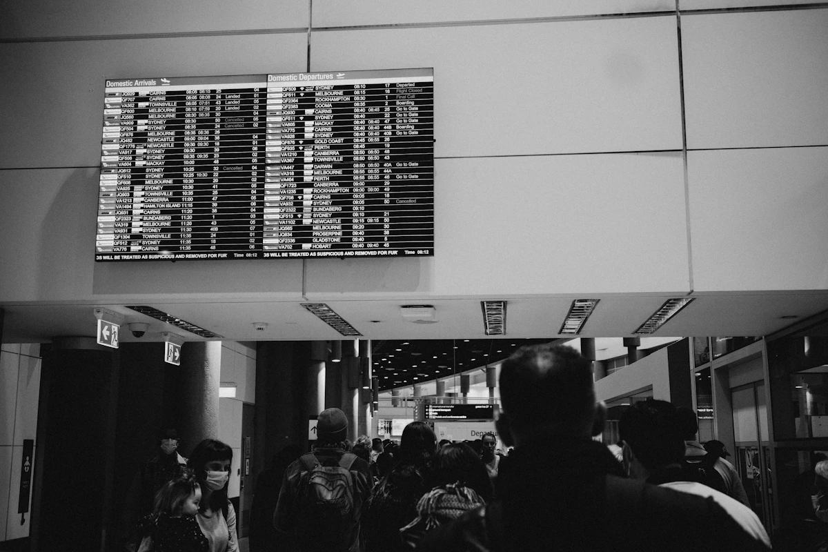 An airport departure board listing flights and gate information