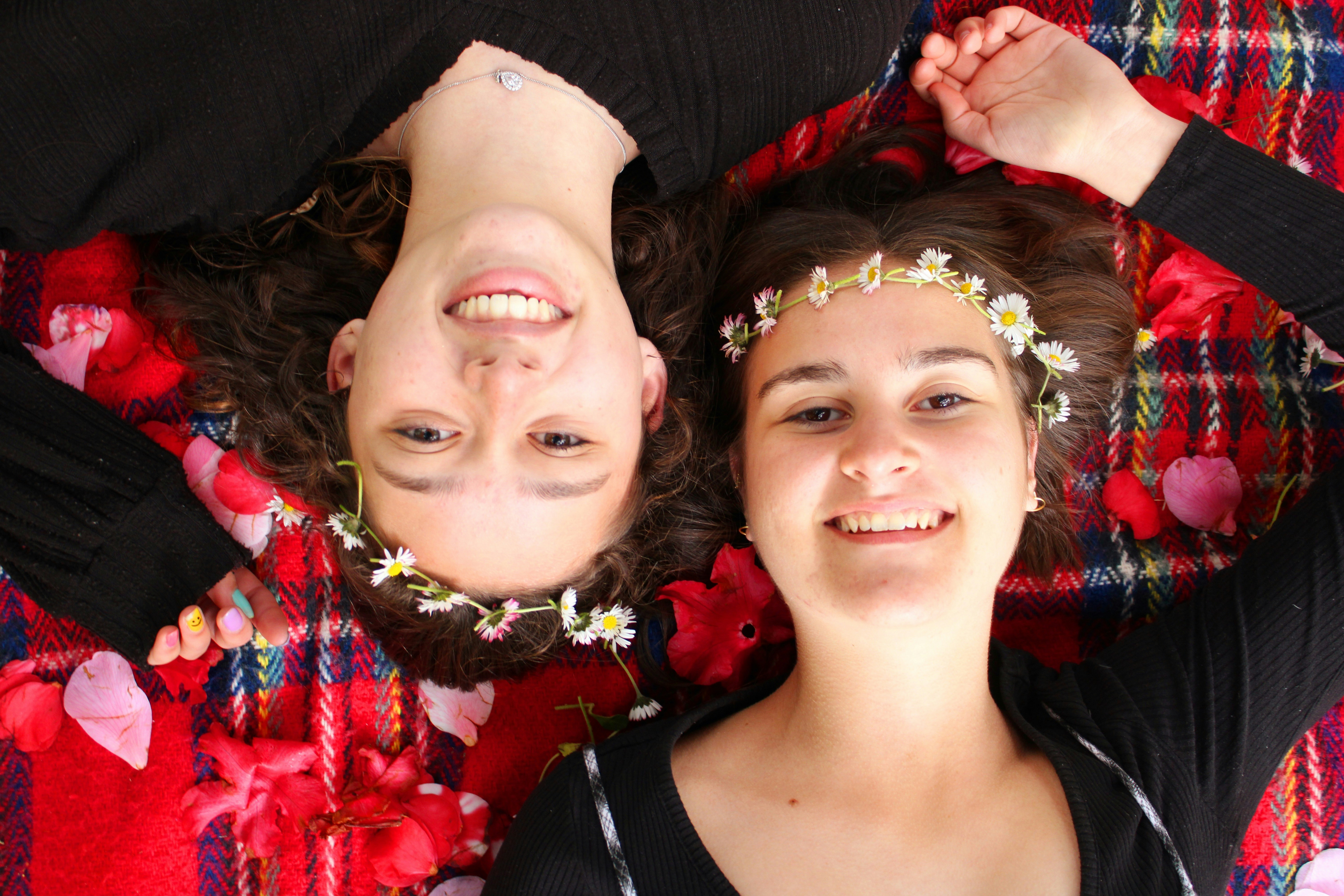 a man and woman wearing flower crowns