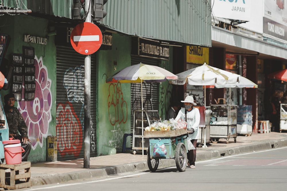 a person pushing a cart full of food