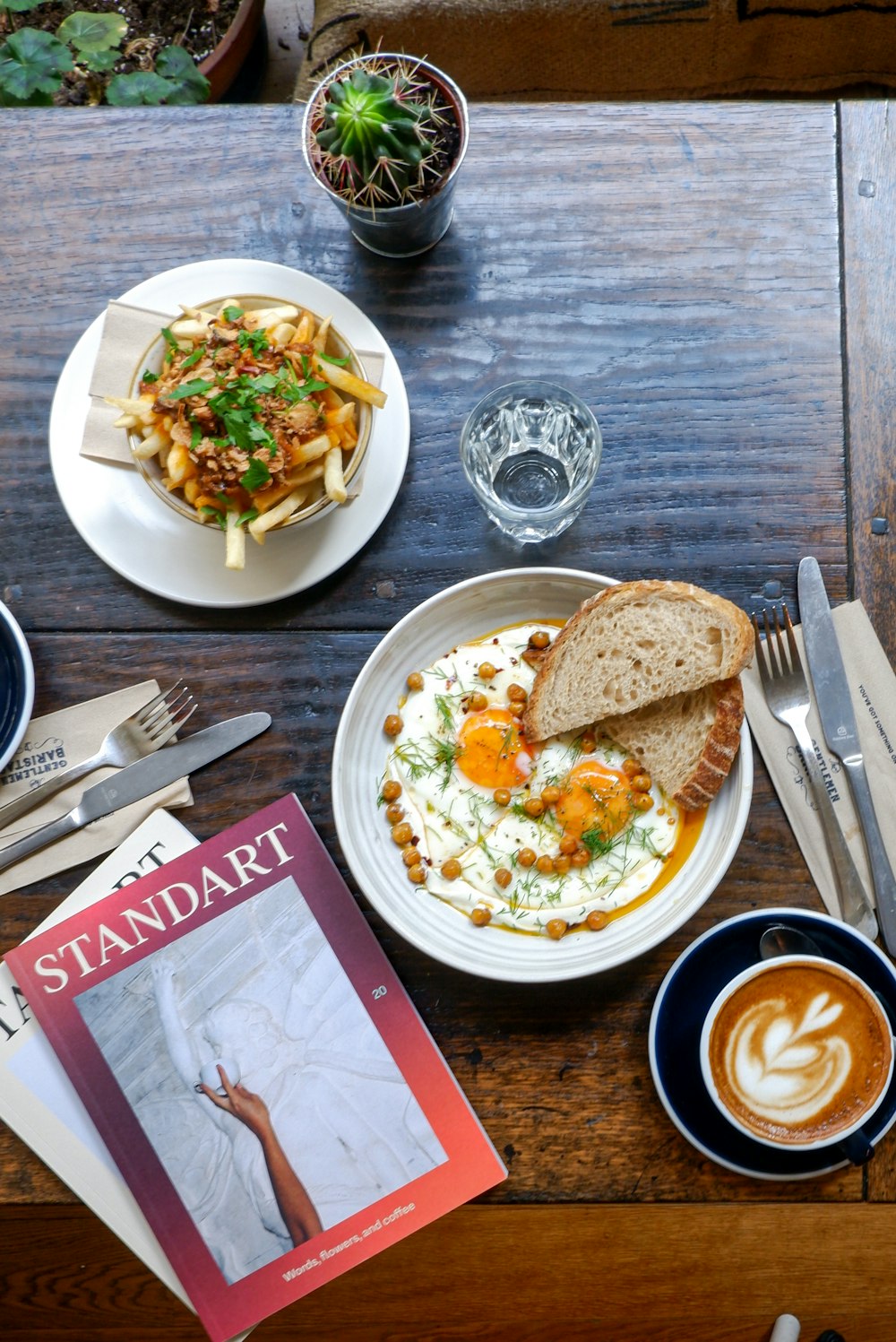 a table with plates of food and a book