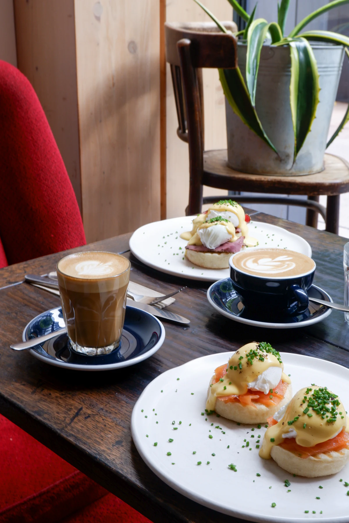 A brunch table with plates of food and coffee