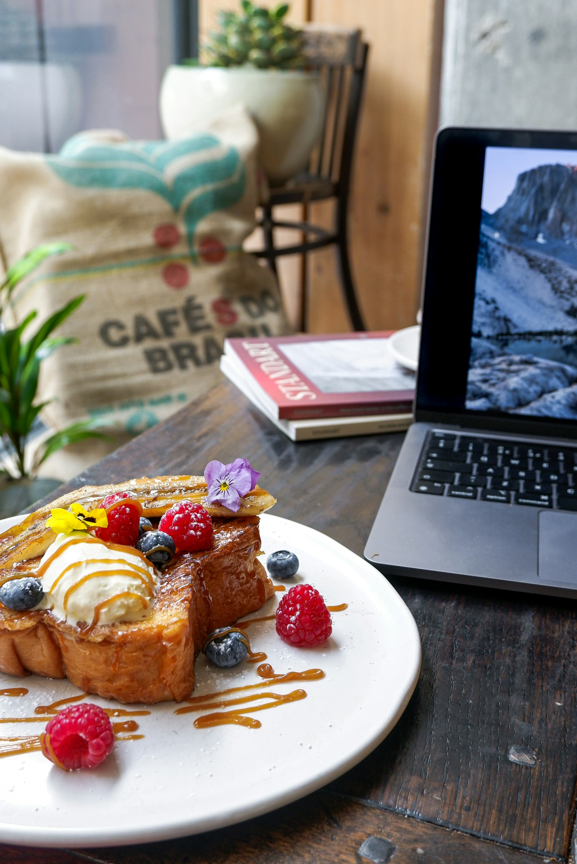 a plate of dessert next to a laptop