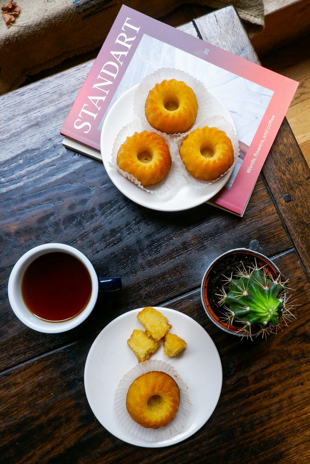 a plate of donuts and a cup of coffee