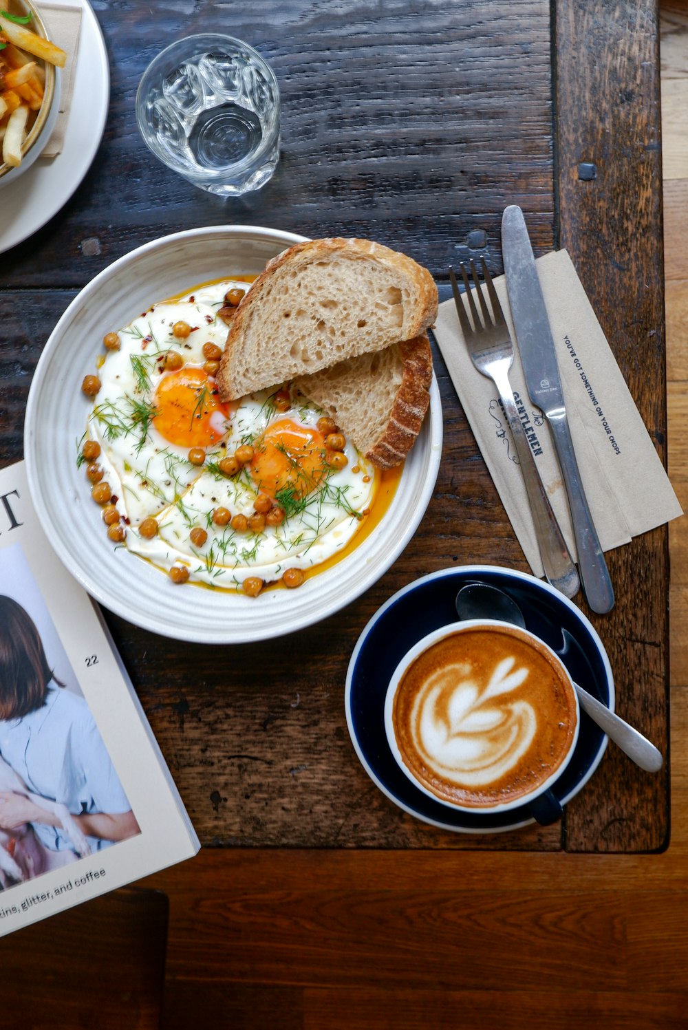 a plate of food and a cup of coffee on a table