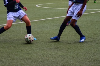 a couple of men playing football