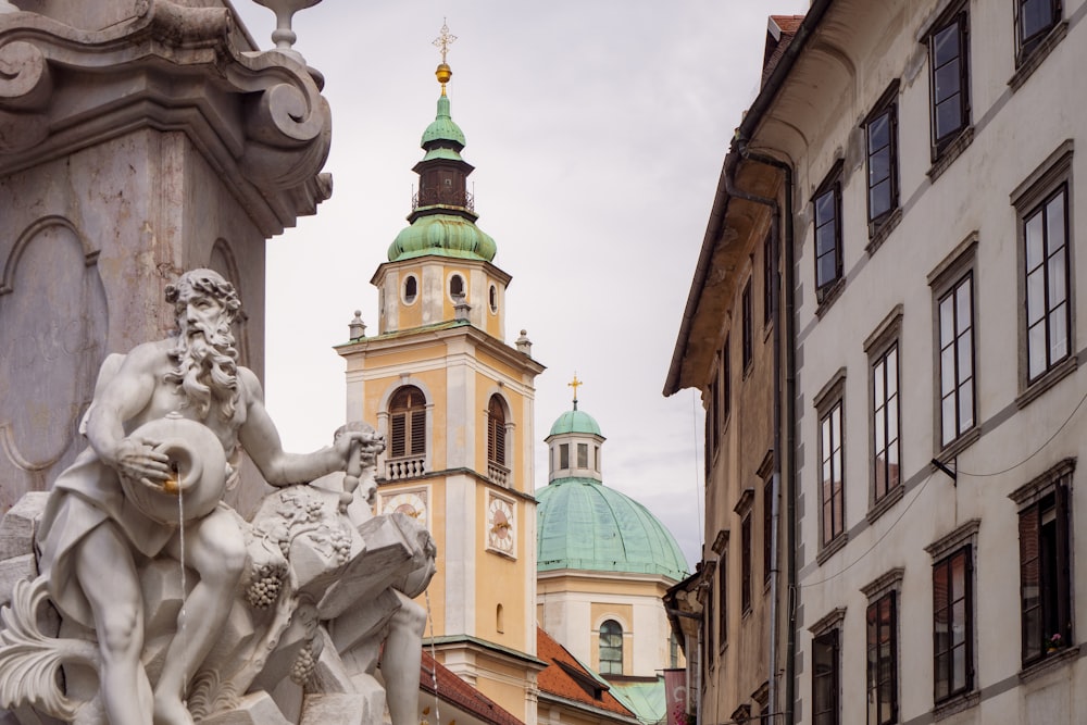 a statue of a person with a beard and a building in the background