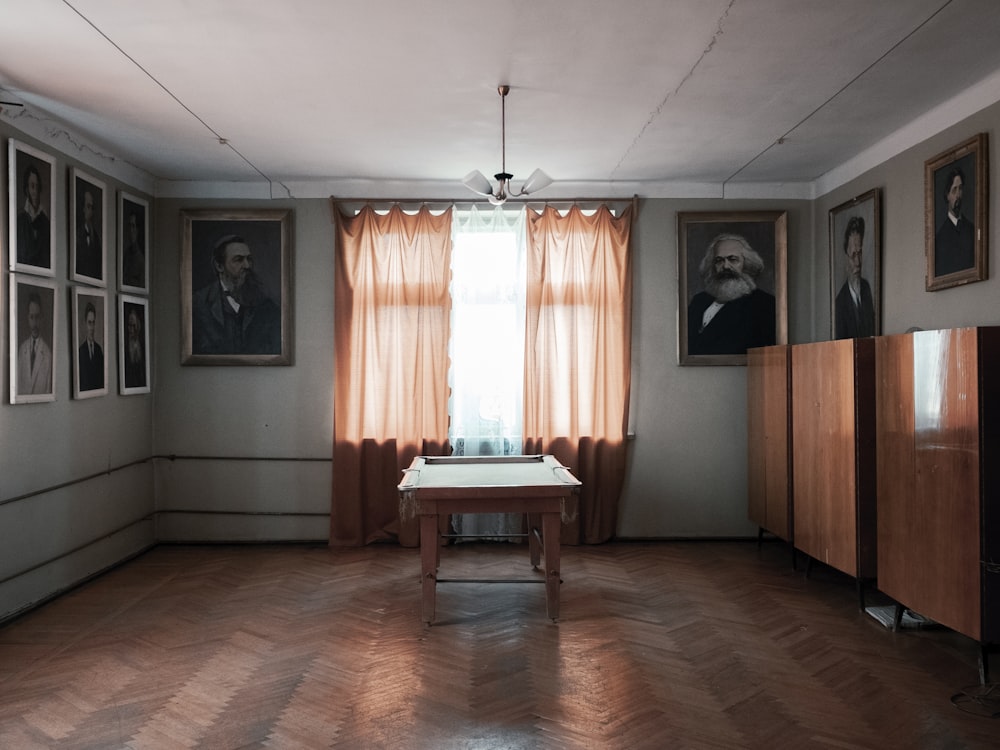 a room with a table and a window with curtains