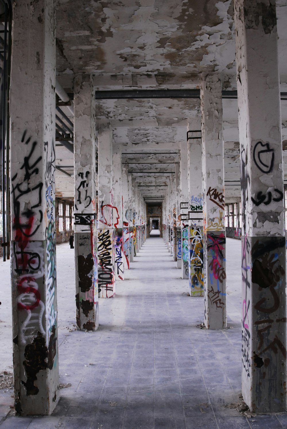 a hallway with graffiti on the walls