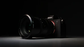 Close-up of a sleek camera model highlighted in a stylish studio setup.