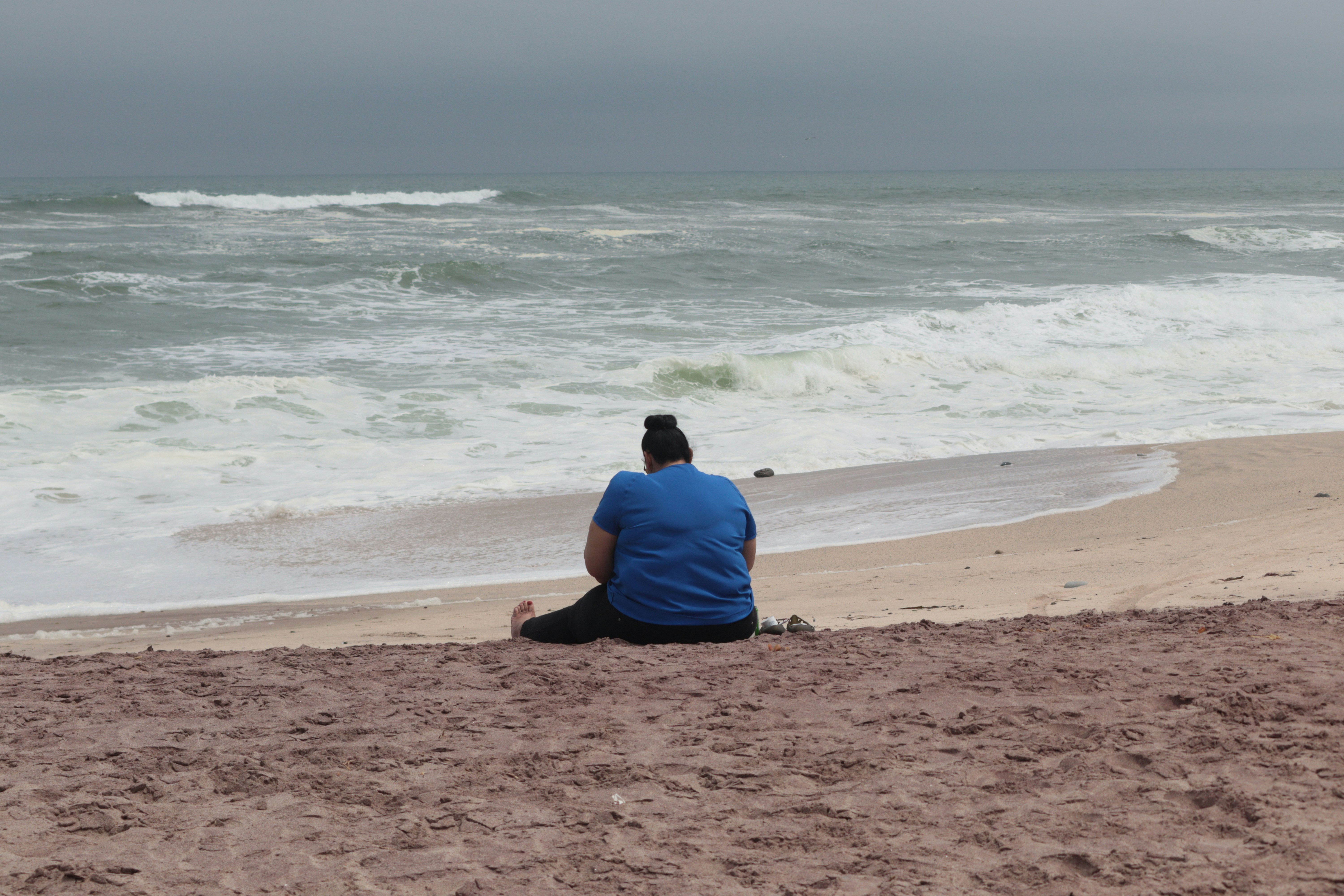 a man sitting on a beach