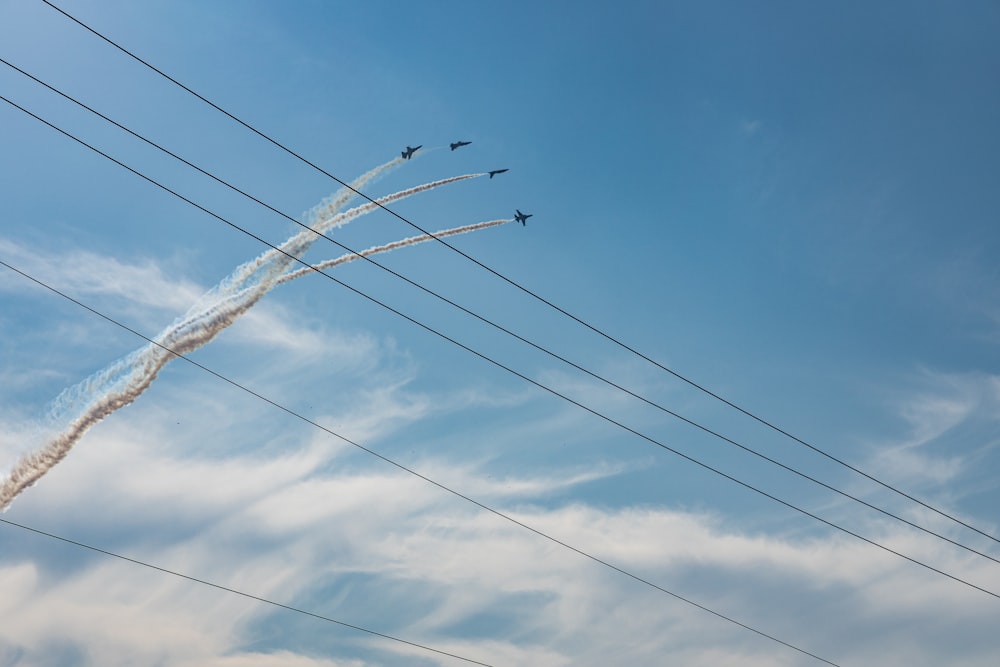 a group of planes fly through the air