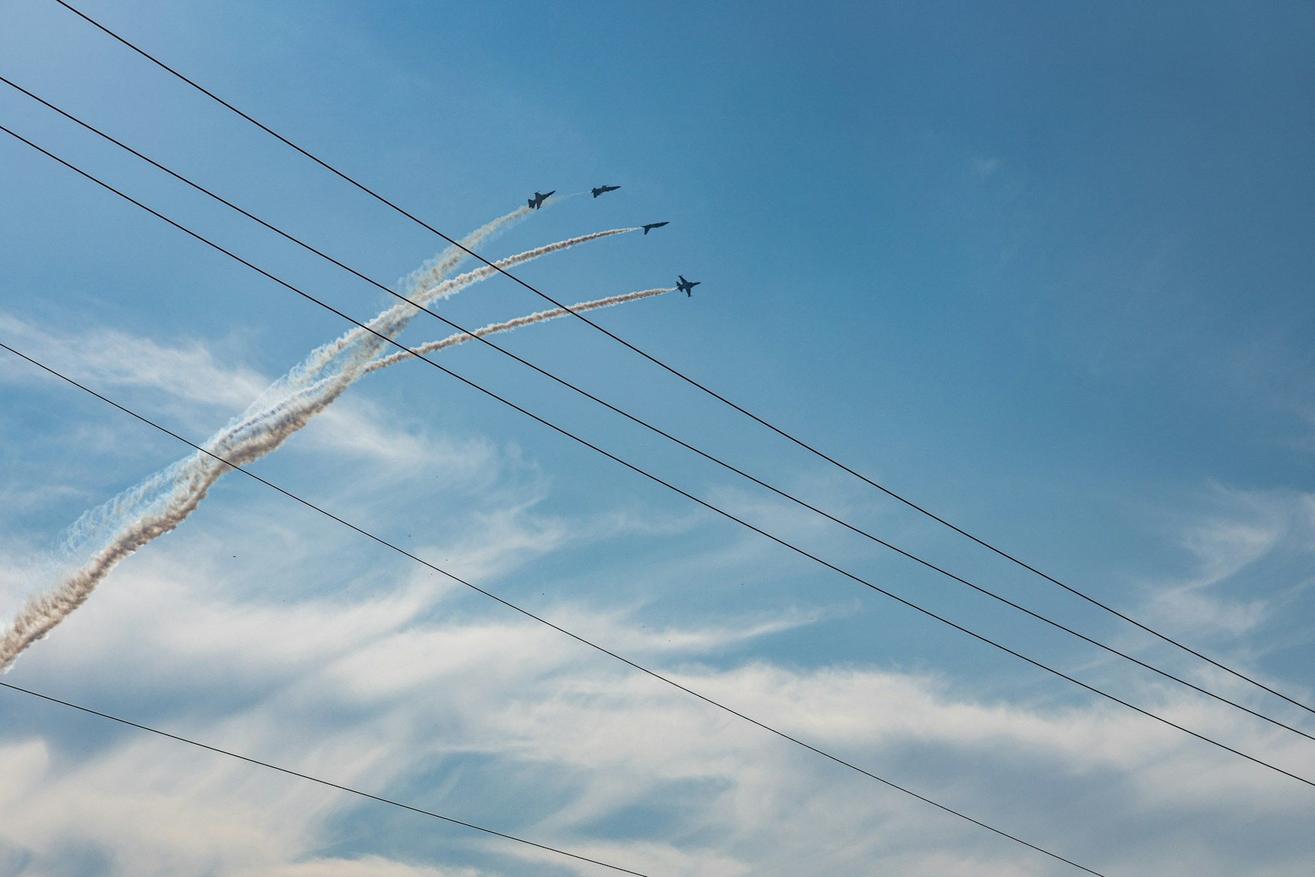 a group of planes fly through the air