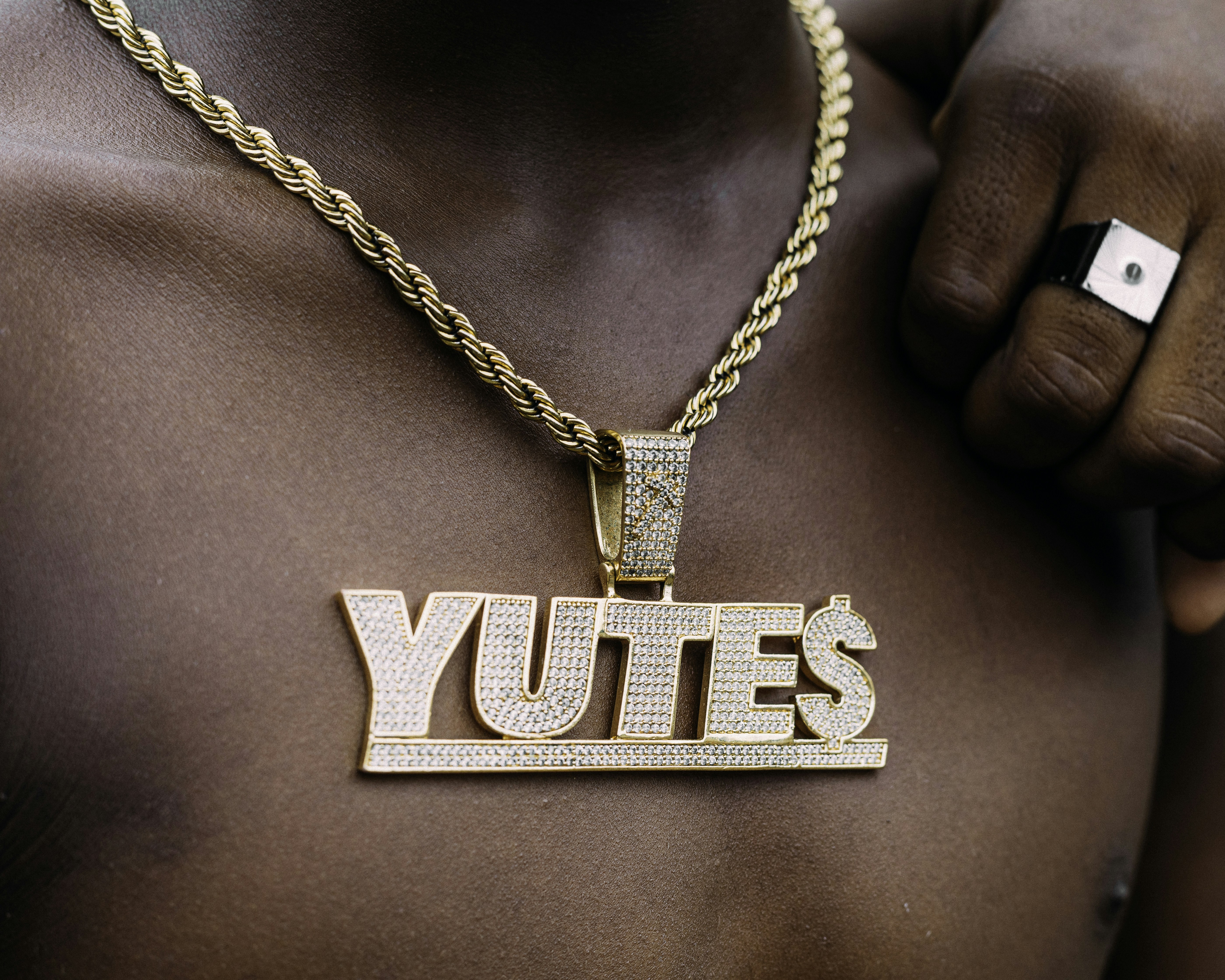 a hand holding a necklace