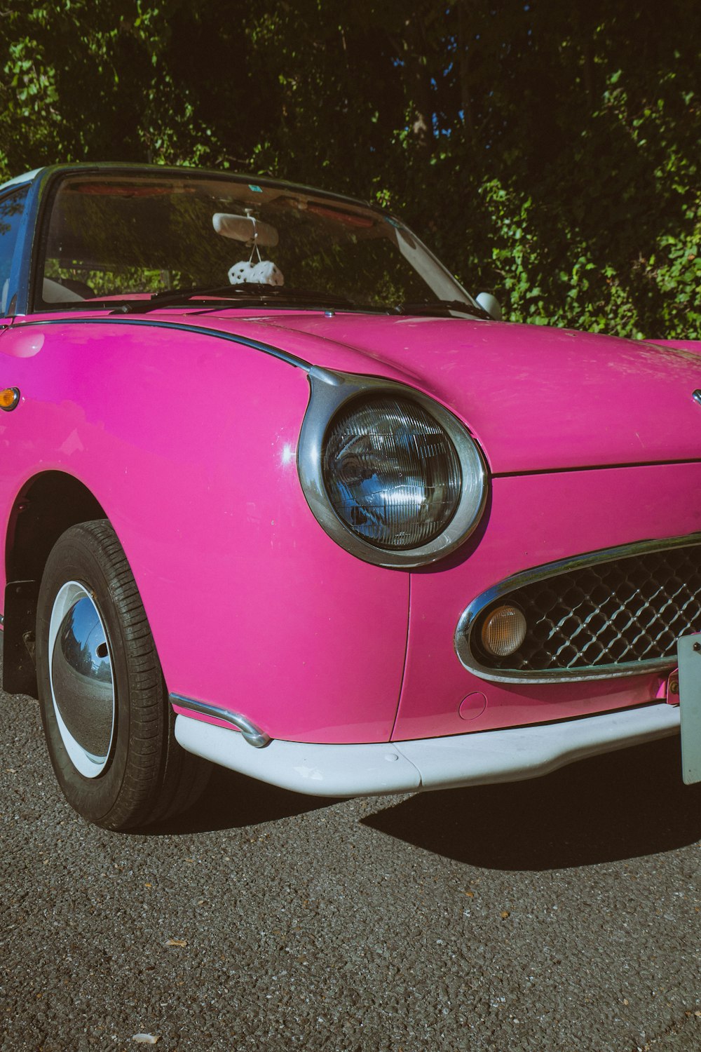 a pink car with a headlight