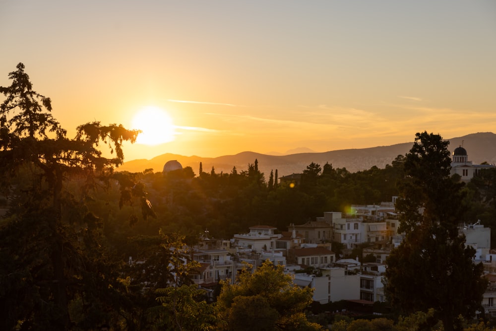 a city with trees and mountains in the background