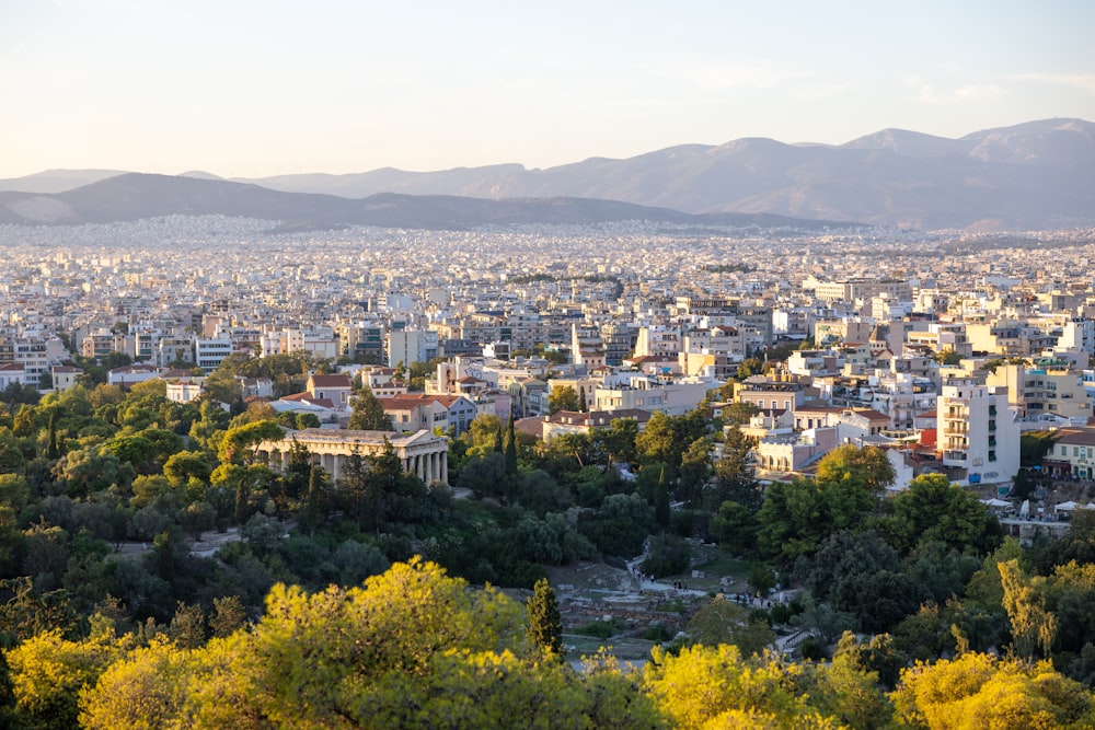 a city with many trees and mountains in the background