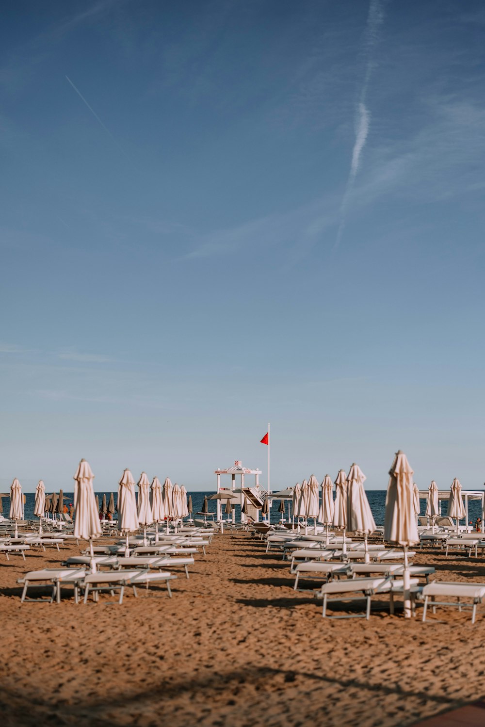 a beach with umbrellas and chairs