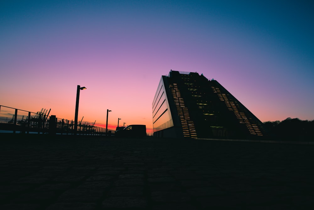 a building with a sunset in the background