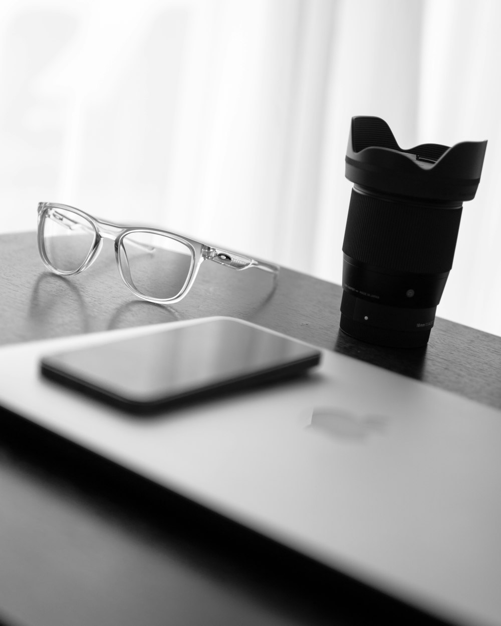 a pair of glasses and a cell phone on a table