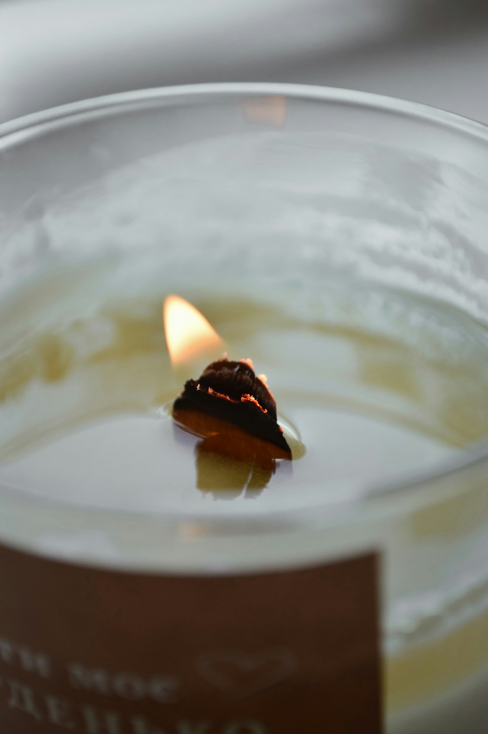 a candle in a glass of liquid