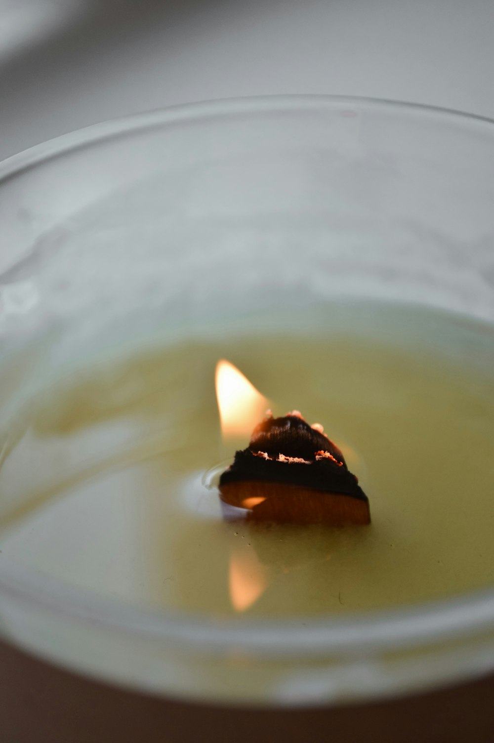 a candle in a glass bowl
