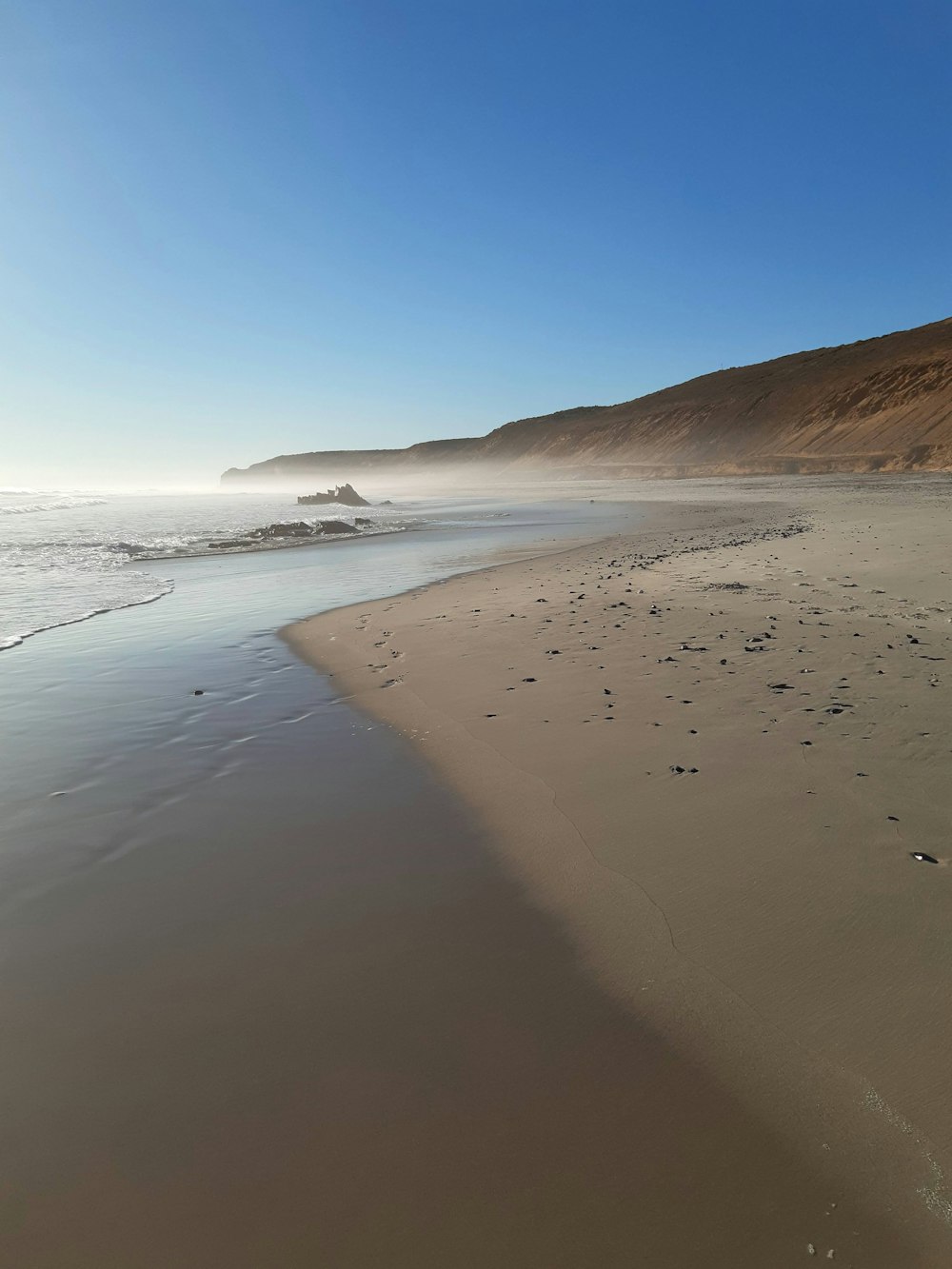 a beach with sand and water