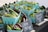 Baskets of fresh green and burgundy okra, along with shishito peppers, are displayed at a market stall. Chalkboard signs in small wooden stands indicate prices for each item. The produce appears fresh and vibrant, arranged neatly in blue containers.