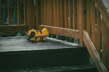 a toy truck on a wooden bridge
