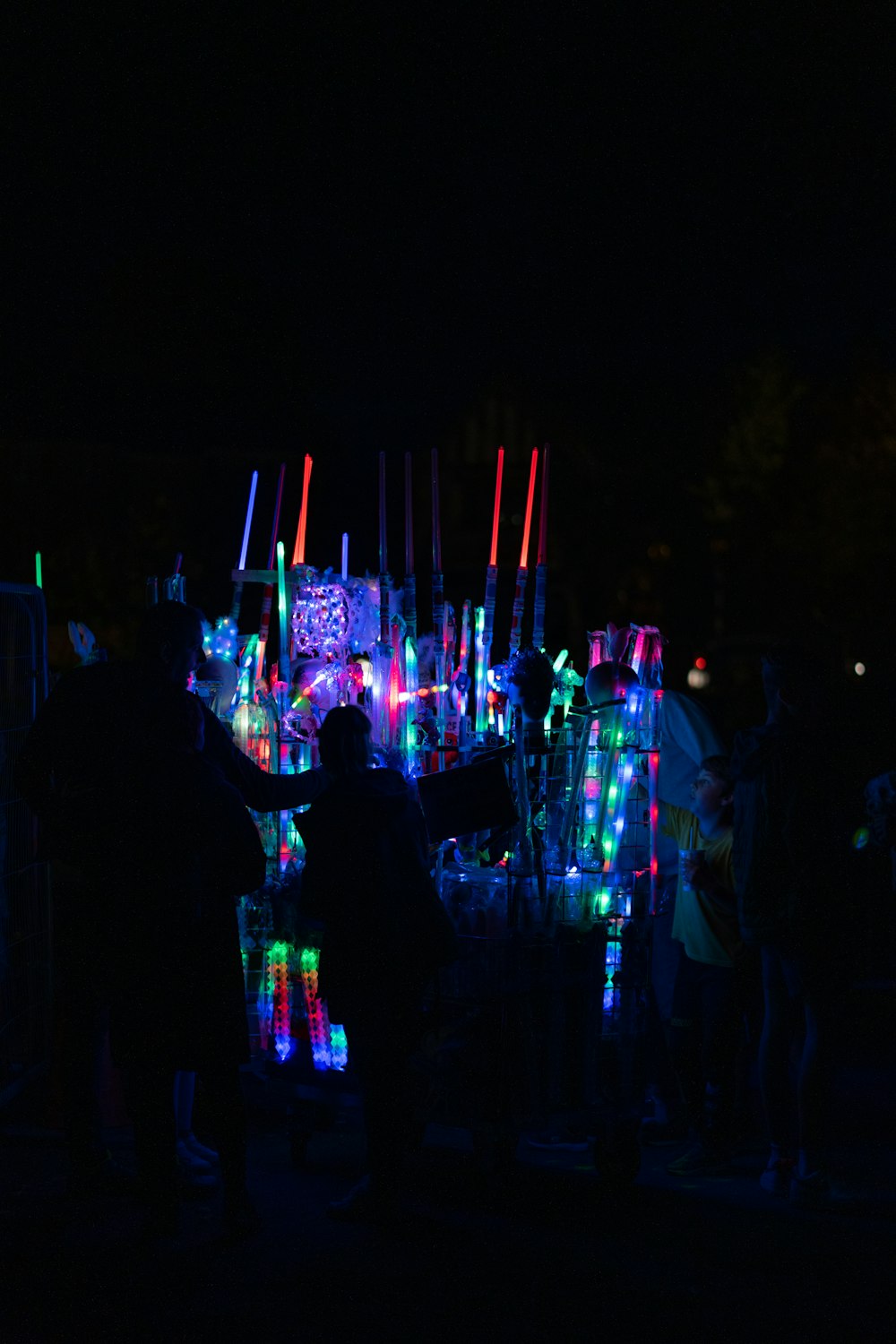 a group of people standing in front of a lit up stage