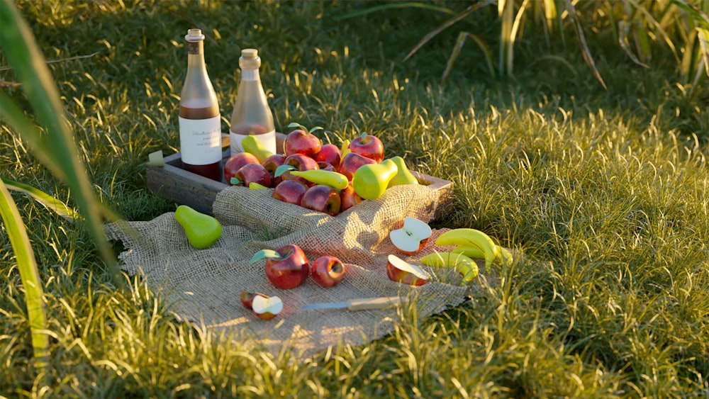 a plate of food and bottles on grass