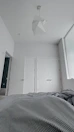 Spacious bedroom with minimalist design and soft linens.