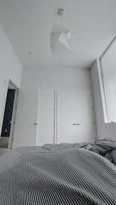 Bright bedroom with comfortable bed and minimalist style.