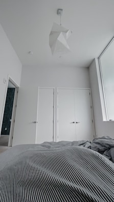 Spacious basement bedroom featuring fresh white walls and modern fixtures post-remodel.