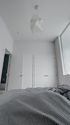 A serene bedroom featuring soft colors and minimalistic design.