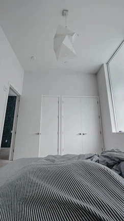 Minimalist bedroom featuring clean lines and soft neutral tones.
