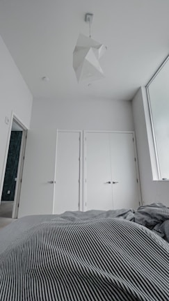 A minimalist bedroom with a calming color palette and contemporary furnishings.