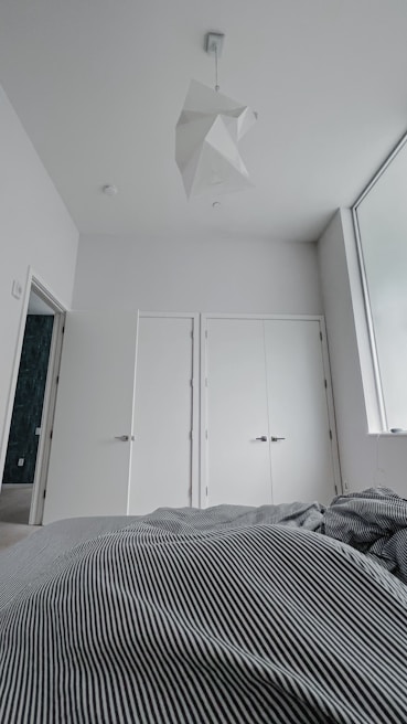 Modern bedroom interior featuring calming colors and minimalist design for restful comfort