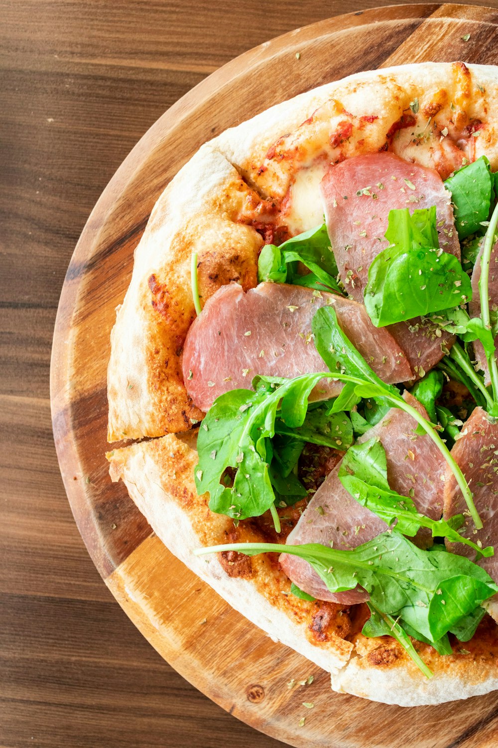 a couple of pizzas on a wooden board