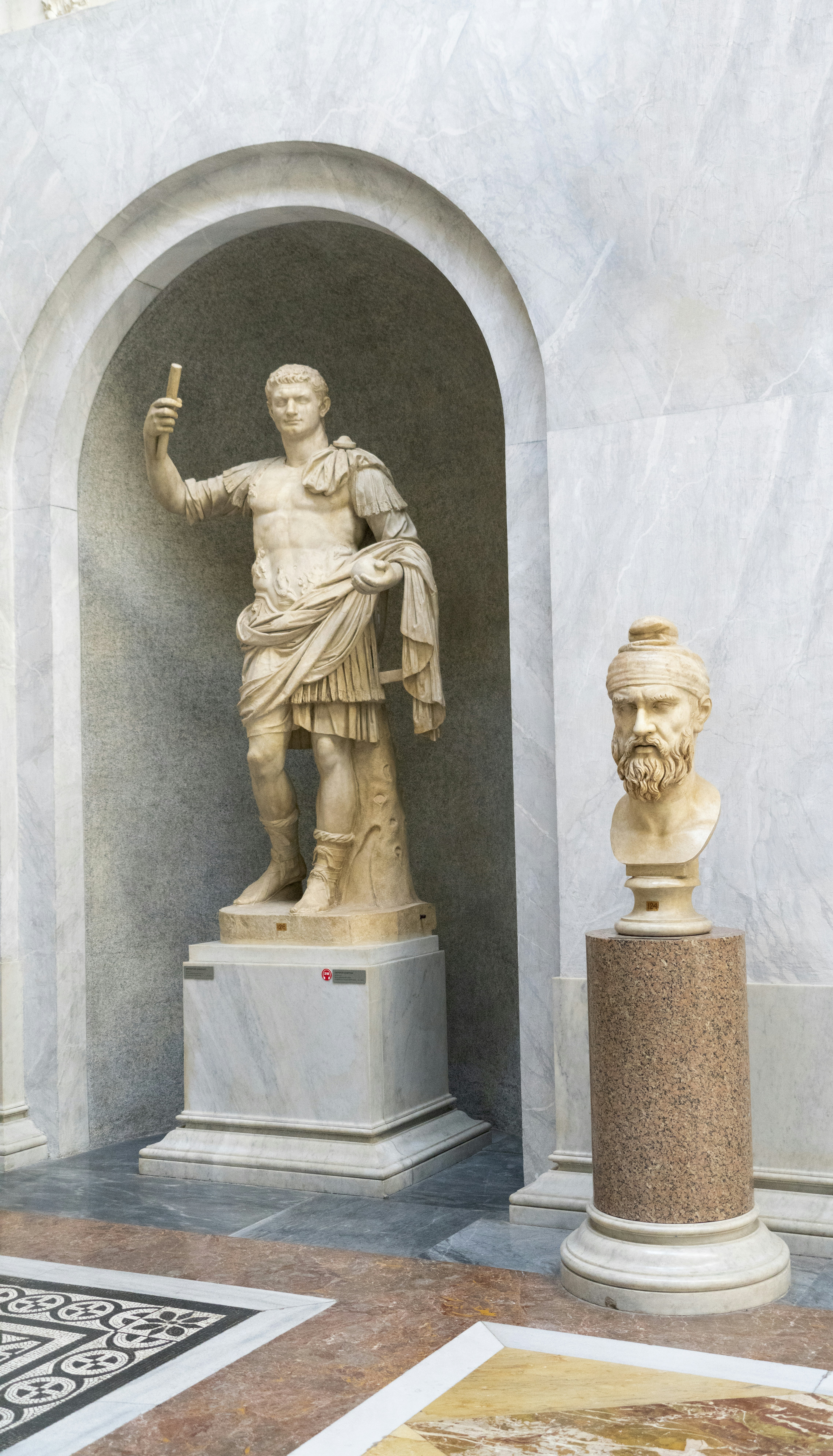 a statue of a person holding a staff