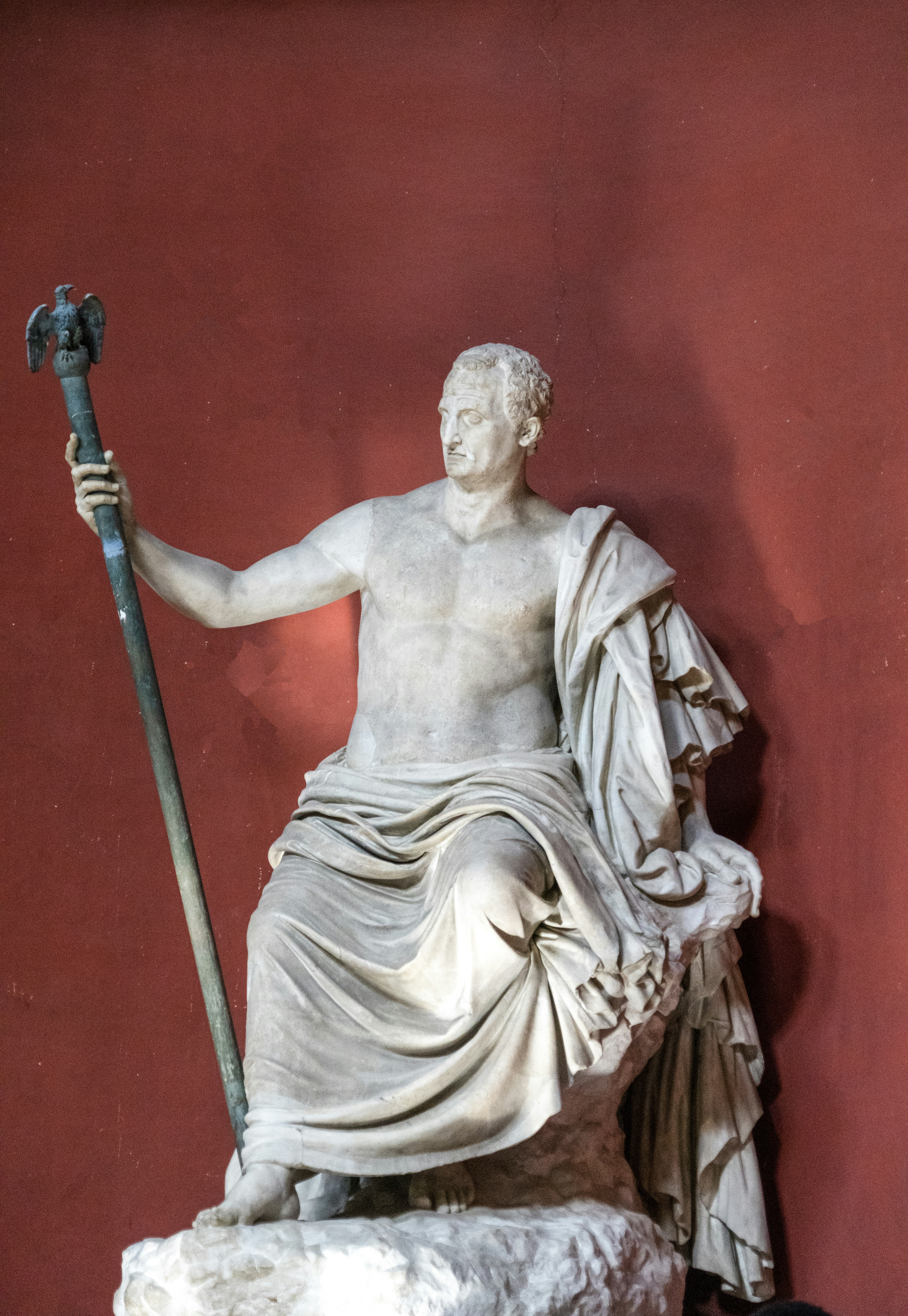 a statue of a person holding a staff