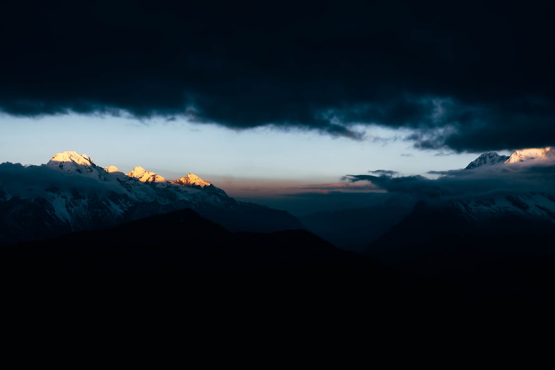 a mountain range with clouds,