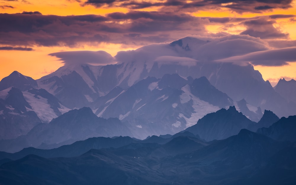 a mountain range with clouds